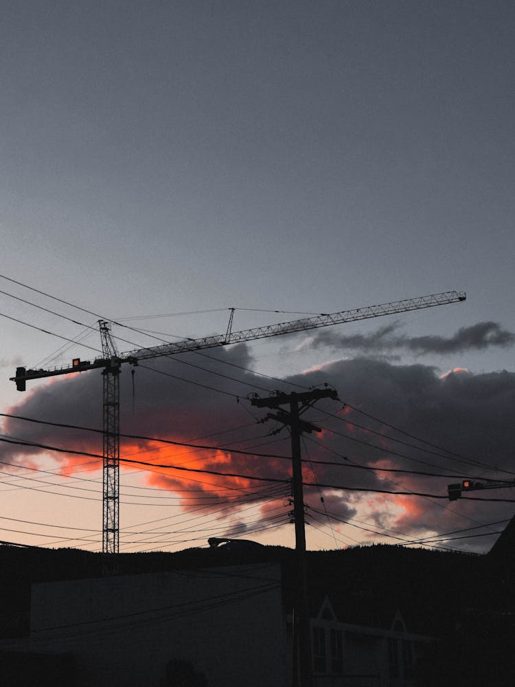 Construction Cranes During Sunset