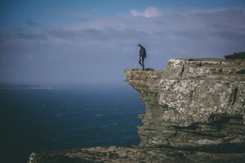 Man Standing on Cliff