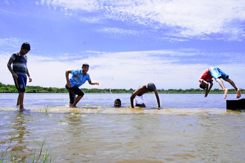 Free Group of children enjoying beach time in Fuvahmulah, Maldives. Stock Photo