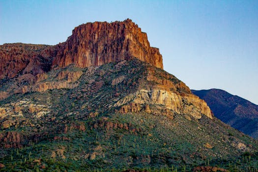 Captivating view of an Arizona mountain with rocky formations at dusk.