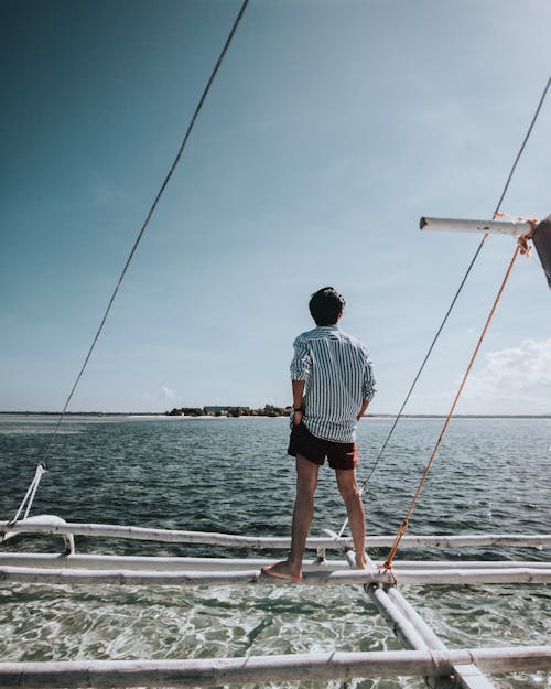 Free Man Standing on Boat Stock Photo