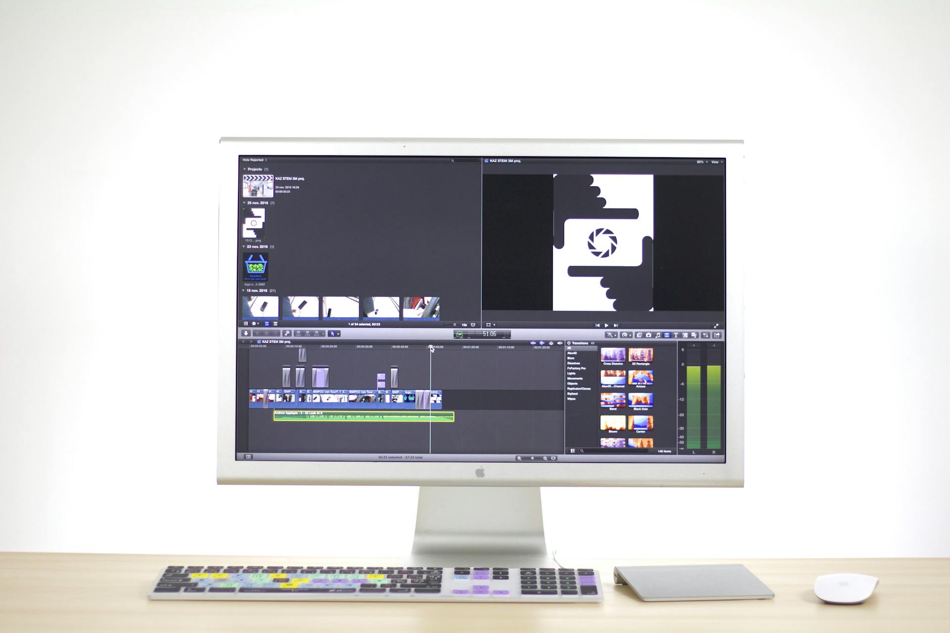 A sleek computer monitor displays video editing software in a modern workspace.