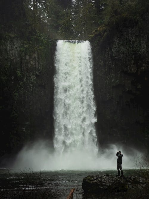 Free Photo of Person Standing Near Waterfalls Stock Photo