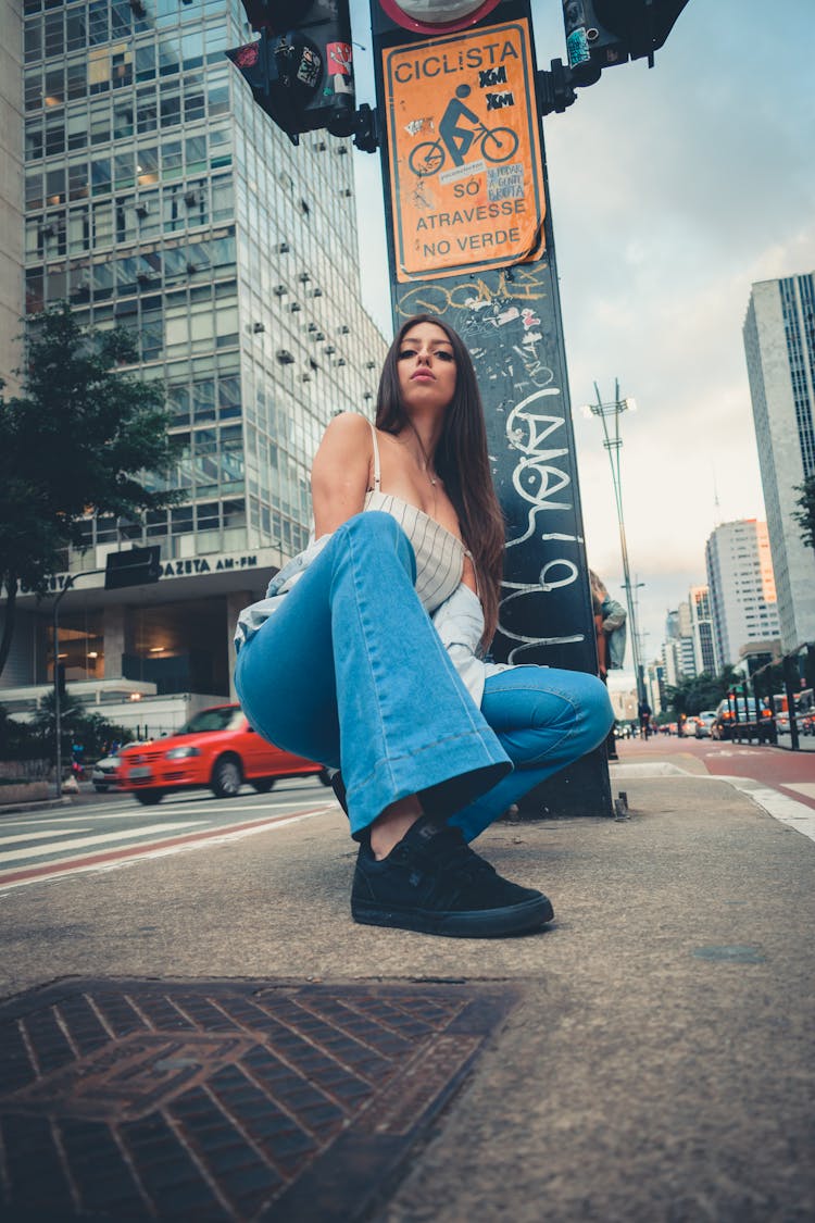 Low Angle Photo Of Woman Squat Posing On Sidewalk