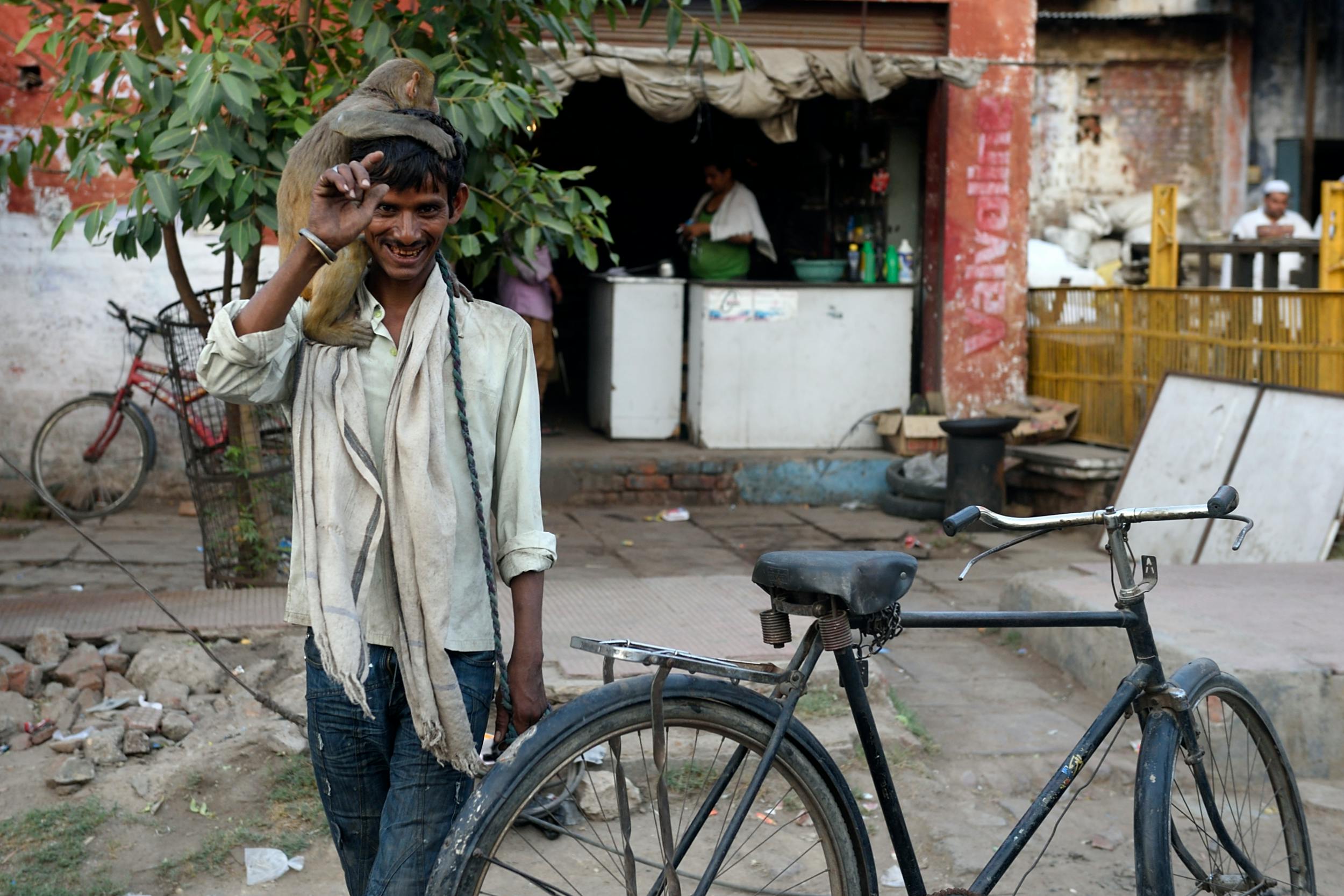 A man carrying a monkey. | Photo: Pexels