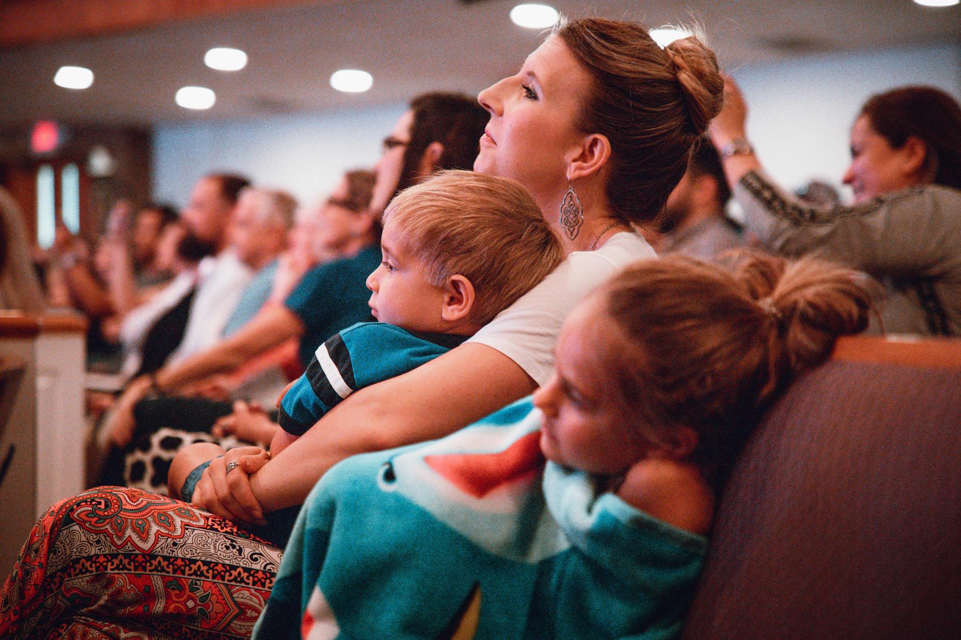 Parent Ignoring Audience While Comforting Toddler In Public Setting