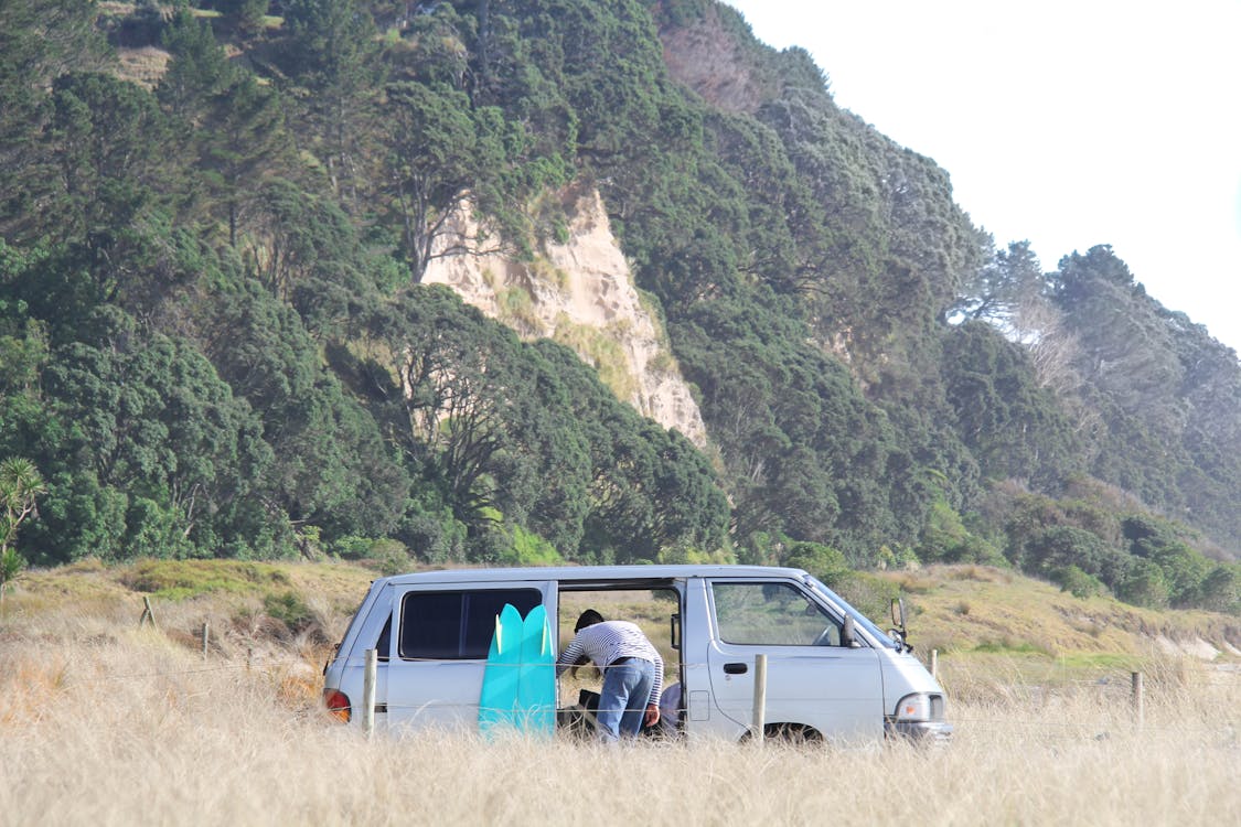 Free Person Bending Forward Inside Van Stock Photo