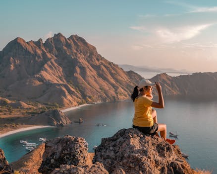 在印度尼西亚帕达尔岛，一名女子正在欣赏令人惊叹的日出景色