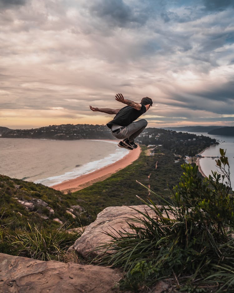 Time Lapse Photography Of Man Jumping From Mountain Cliff