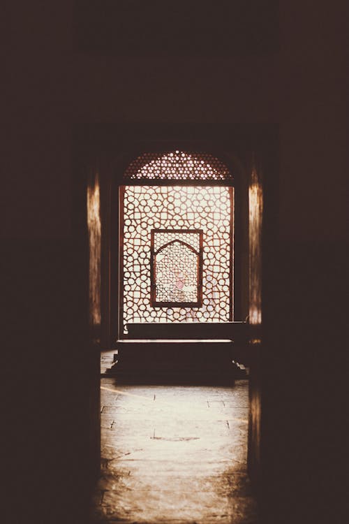 Entrance To A Room With Wooden Divider and Glass