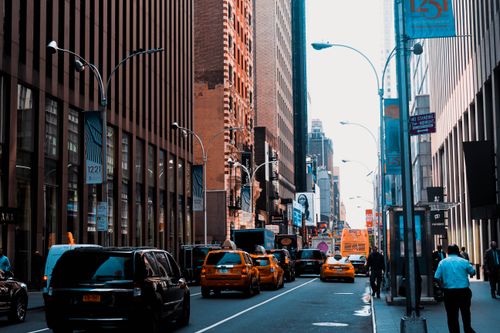 Free Vibrant city street in New York with taxis, tall buildings, and pedestrians. Stock Photo