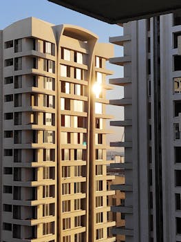 Sunset reflecting off urban high-rise apartment buildings, showcasing modern architecture.