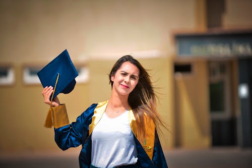 Woman Wearing a Blue and Yellow Graduation Toga