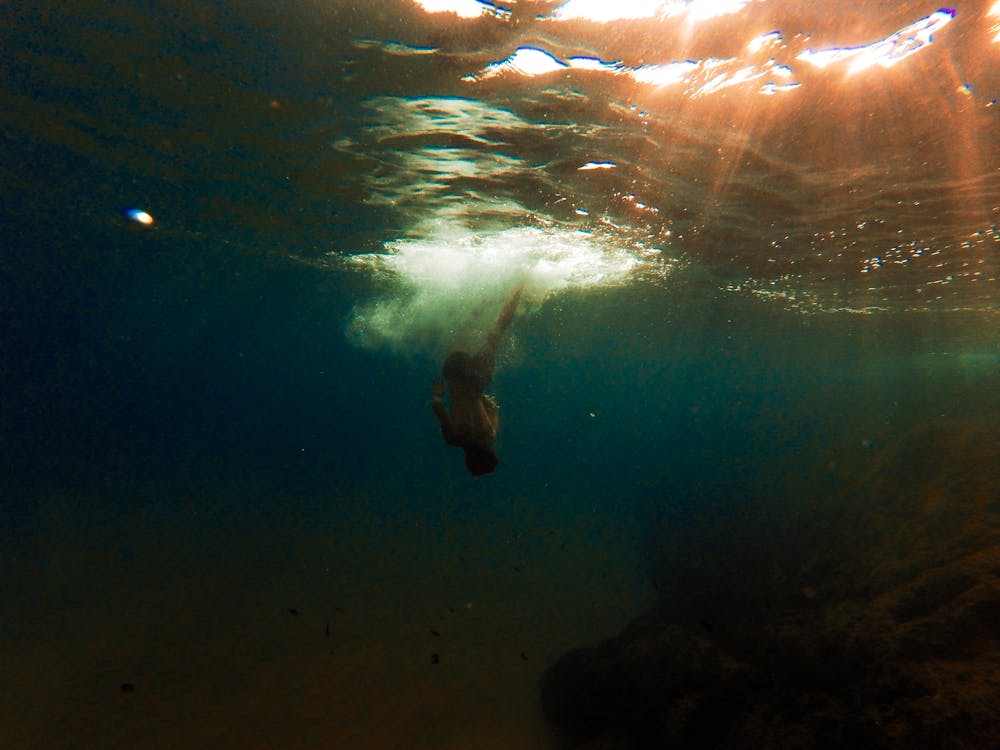 Free Person Swimming Underwater Stock Photo