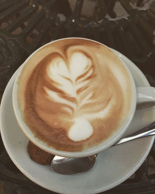 Free A close-up shot of a cappuccino featuring elegant latte art, perfect for coffee lovers. Stock Photo
