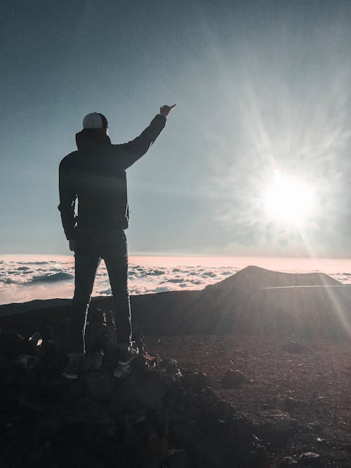 Man Standing Near Sea of Clouds