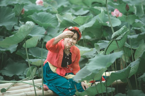 Free Woman Surrounded by Water Lilies Stock Photo