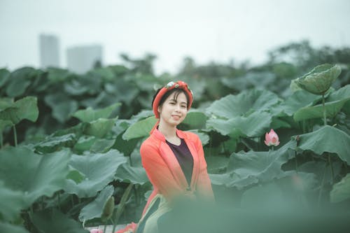 Free Smiling Woman In The Middle Of Plant Field Stock Photo