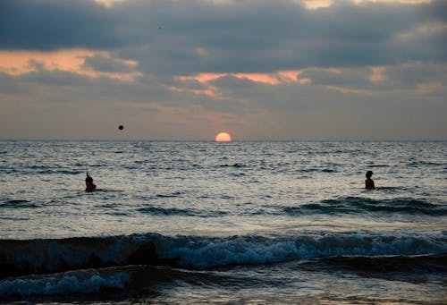 Silhouette Of People At The Beach