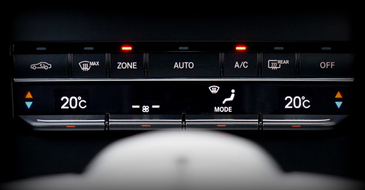 Close-up image of a car's climate control panel with digital temperature display.