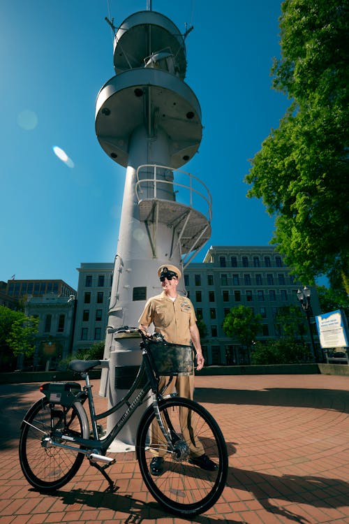 Officer With Bicycle Near Tower