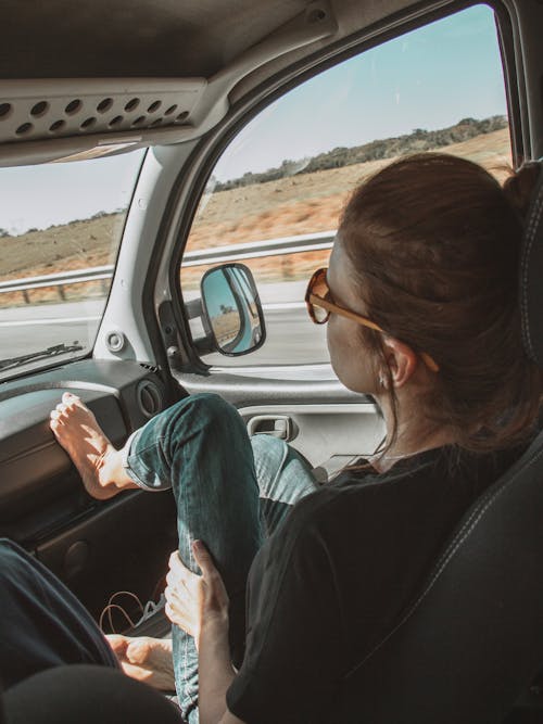 Free Woman With Foot Up Inside A Vehicle Stock Photo