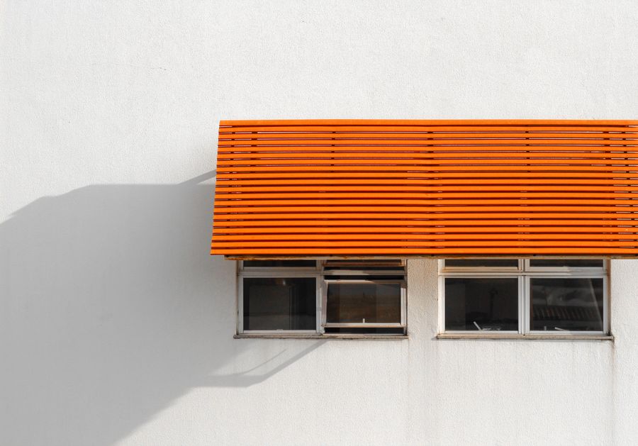 Stock photo of a clean orange metal canopy on a building