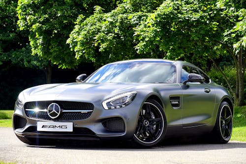 Free Silver Mercedes-benz Amg Gt Coupe Parked Beside Green Leaf Tree Stock Photo