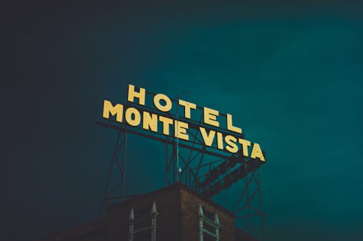 Illuminated Monte Vista hotel sign against a dark sky in Flagstaff, Arizona.