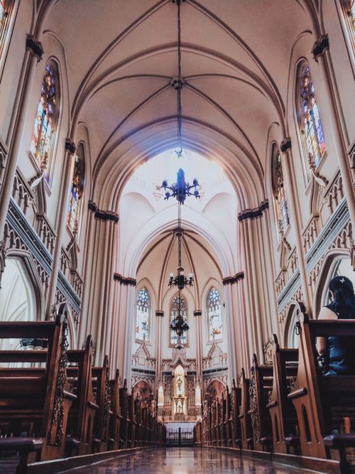 Free Captivating interior view of a Brazilian cathedral showcasing intricate architecture and stained glass artistry. Stock Photo