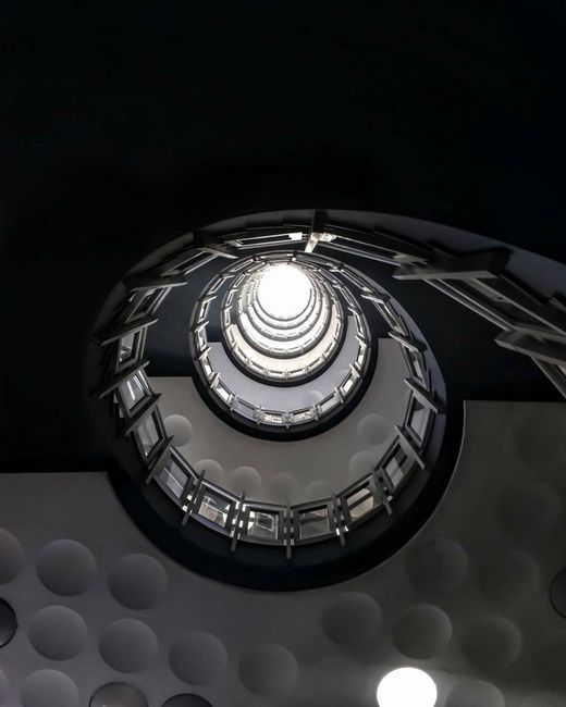 A captivating spiral staircase showcasing modern architecture from an upward perspective.