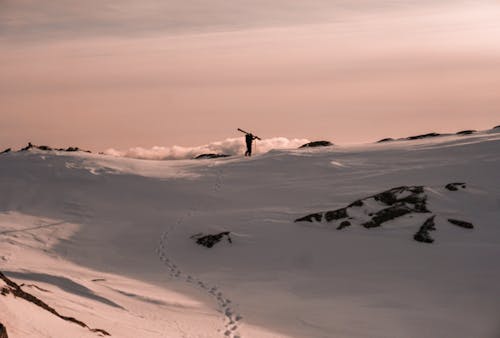 Free Photo of Person Walking on Snowy Field Stock Photo