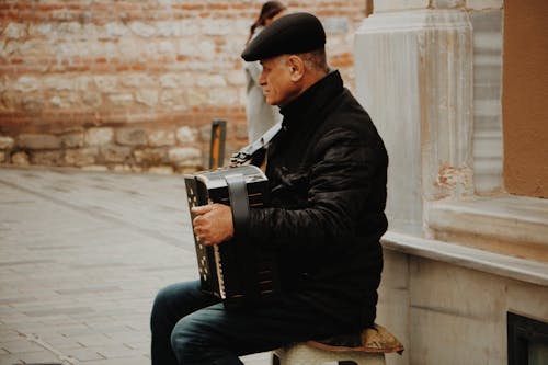 Person Playing Black Musical Instrument