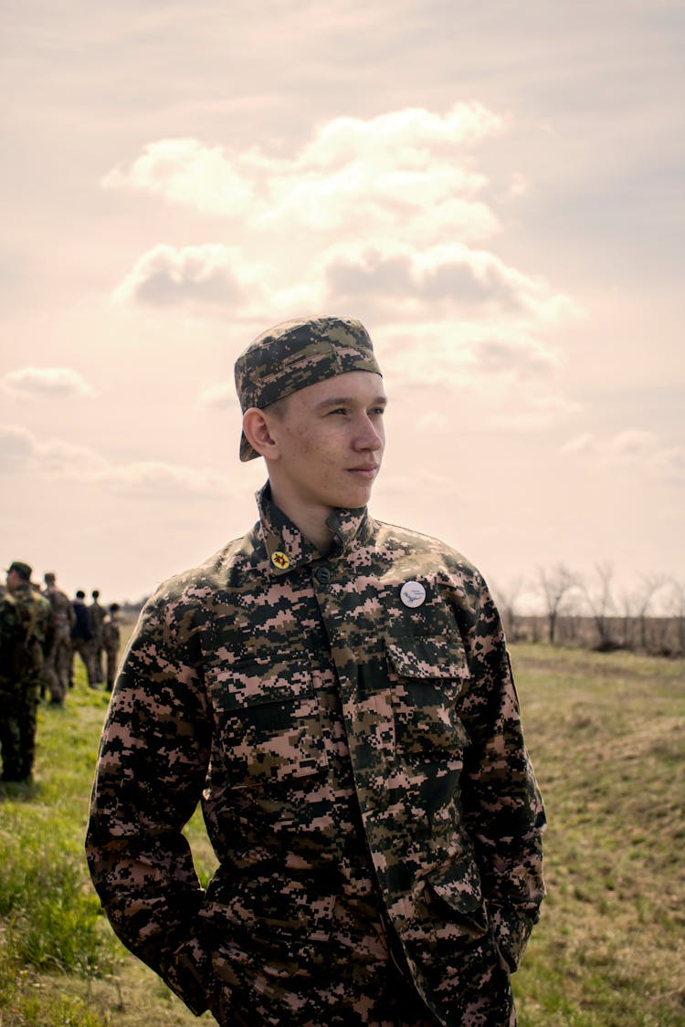 Military Personnel Standing On Grass Field