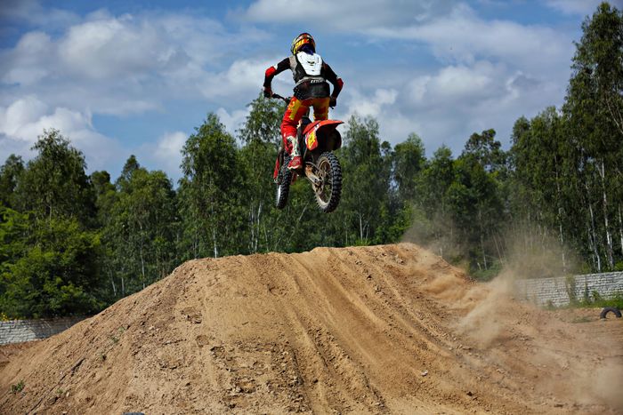Motocross rider jumping over a dirt track, Nishant Aneja on Pexels