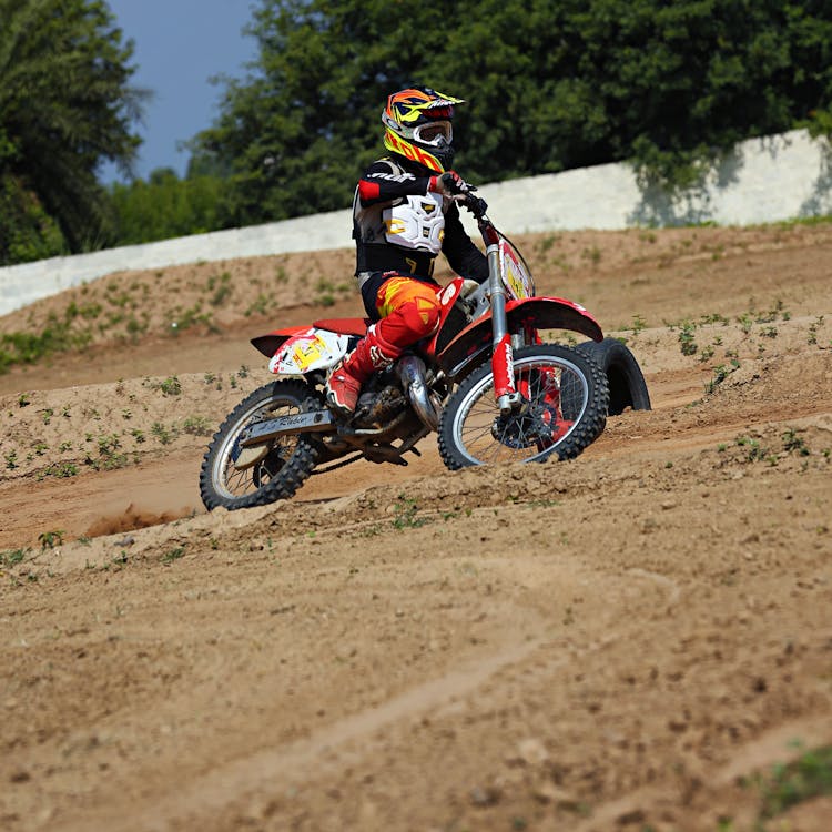 Person Riding Red Dirt Bike