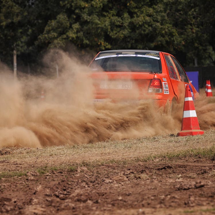 Orange Car Racing With Traffic Cones As Barriers