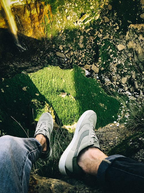 Photo of Person Sitting on Cliff