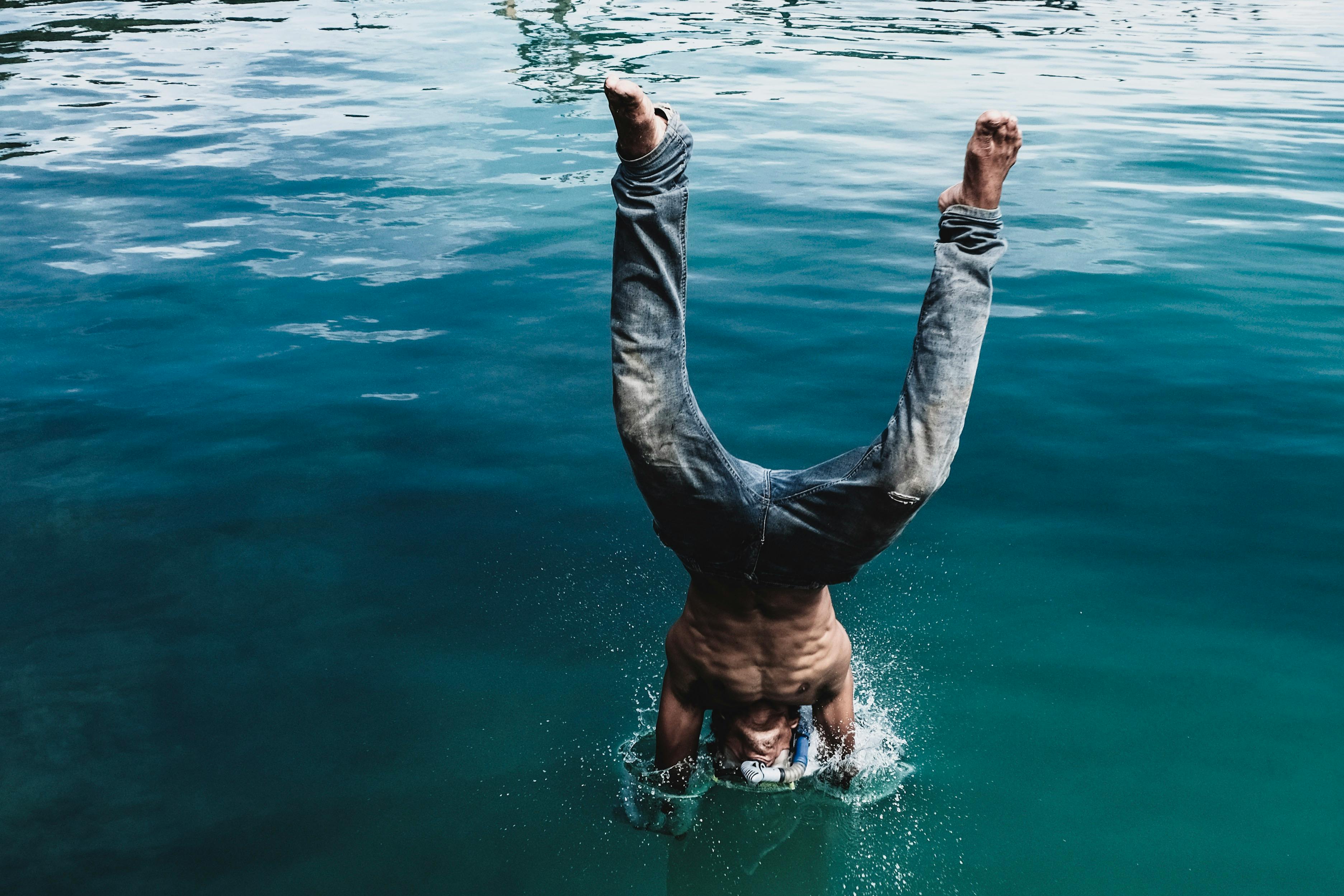 Man Diving into Body of Water · Free Stock Photo