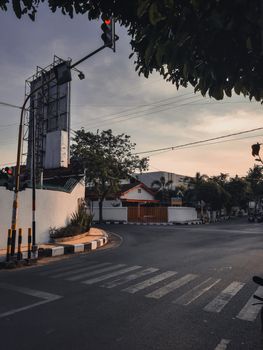 黄昏时分，空荡荡的城市十字路口上，红绿灯和斑马线清晰可见