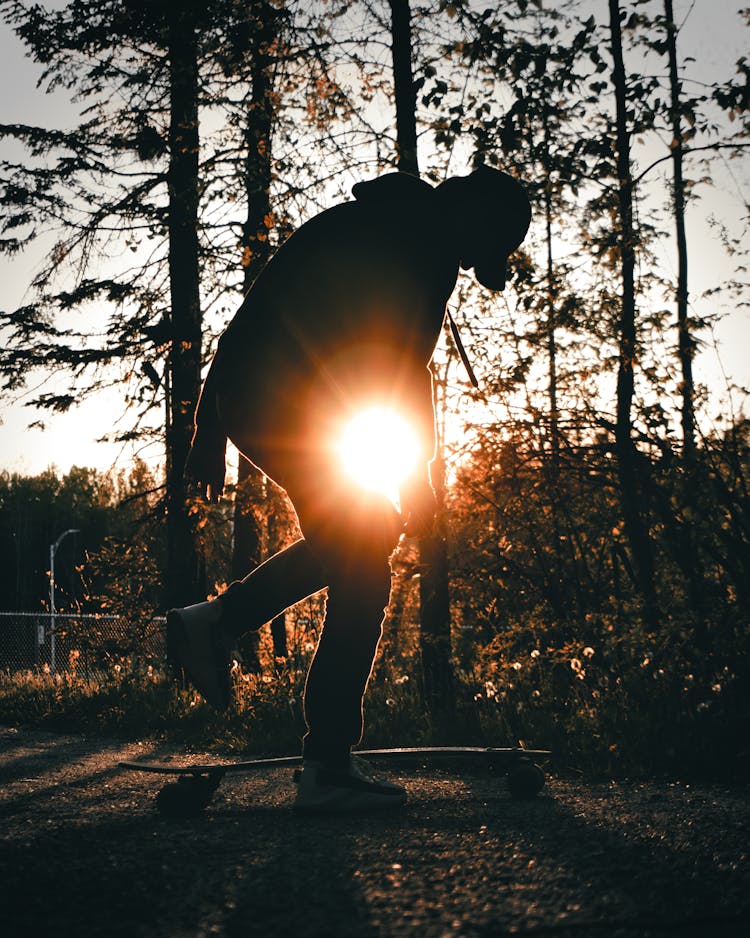 Silhouette Of Person Riding Skateboard During Sunset