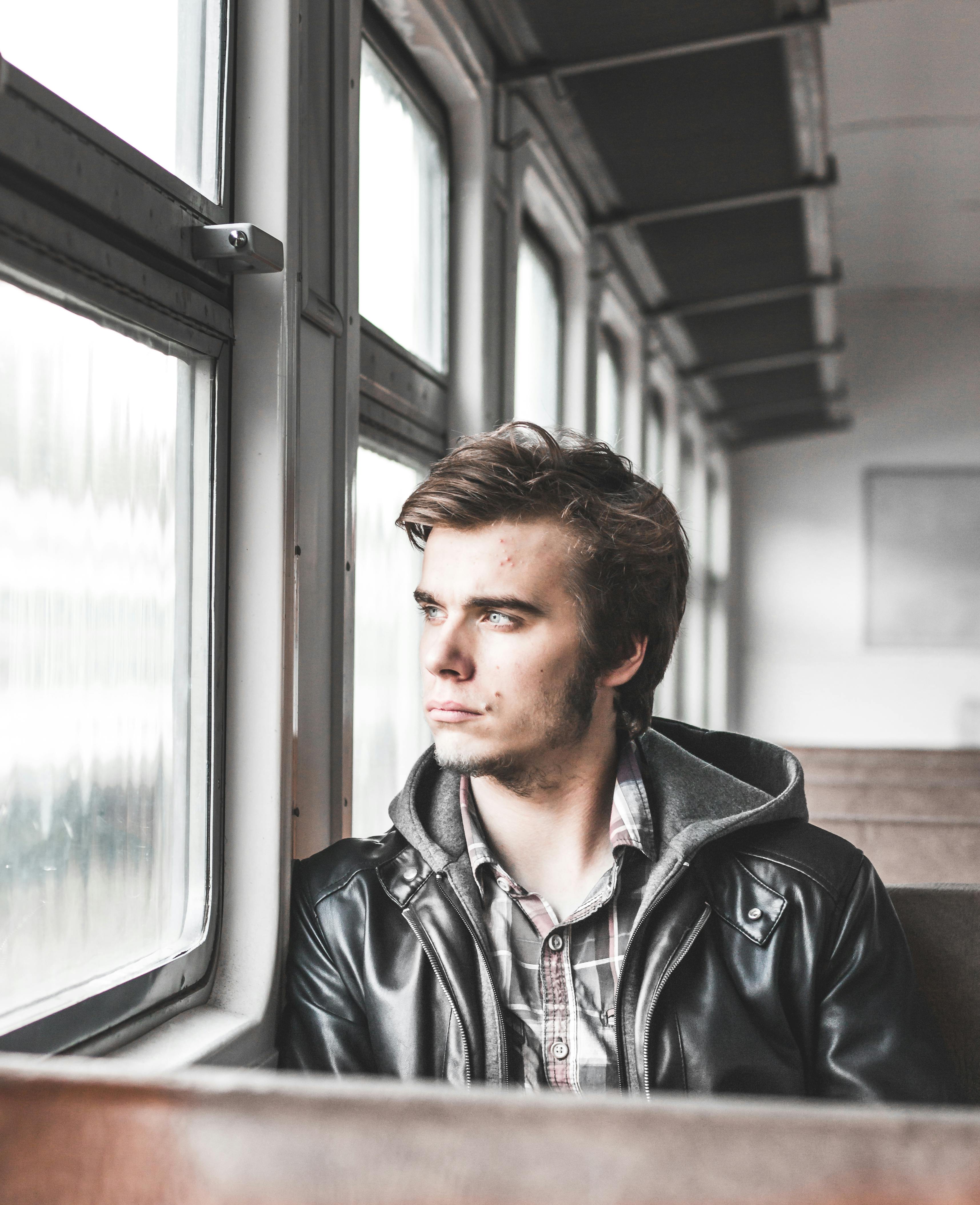 Young Man Looking Out Of Train Window Stock Photo - Download Image