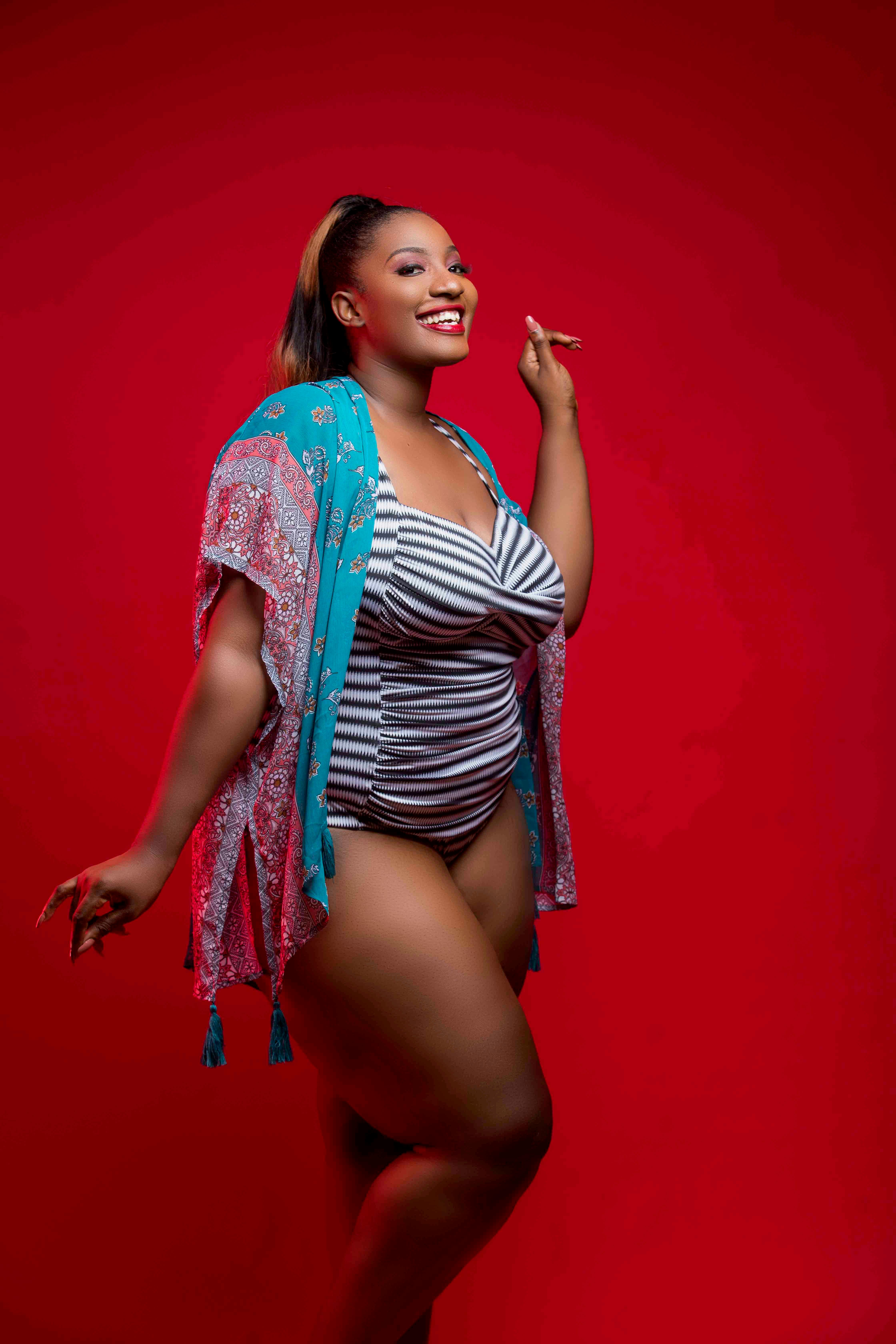 Woman Smiling Wearing White and Black Striped Swimsuit