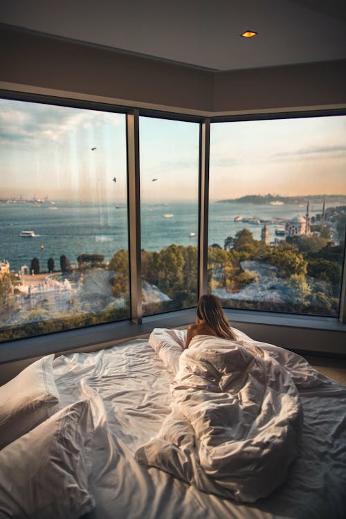 Free Woman Laying Down on Bed Inside Room Stock Photo