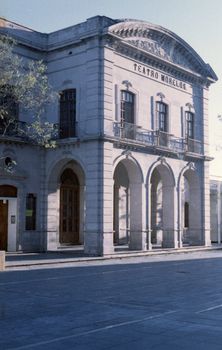 Elegant facade of Teatro Morelos, Aguascalientes, with arched windows and sunlight.