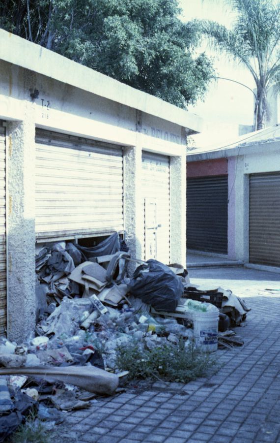 Pile of unwanted items ready for removal outside a garage