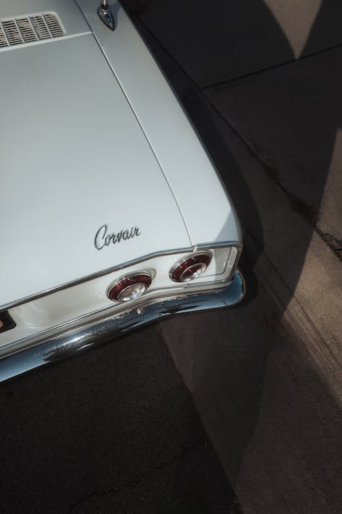 The back of a white car with the word chevrolet on it