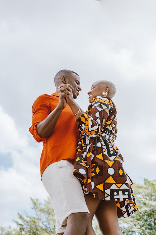 Low Angle Shot of a Couple Dancing Outside 