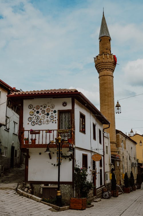 Free stock photo of back alley, cobblestone street, minaret