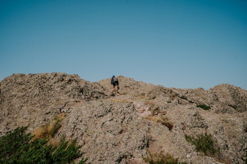 A person walking on a rocky hill